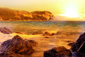 sunset beach with silhouette of tree and mountain