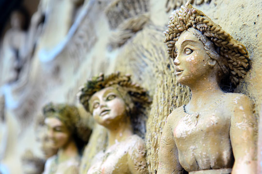 ancient stone sculptures of female images with elements of corrosion