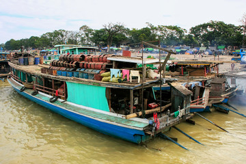 Fototapeta na wymiar Barges anchored at Ayeyarwady river port in Mandalay, Myanmar