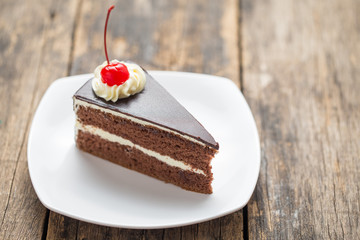 chocolate cake slice on plate on wooden table