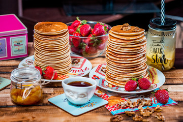 Pancakes with strawberry,walnut and caramel for a breakfast.