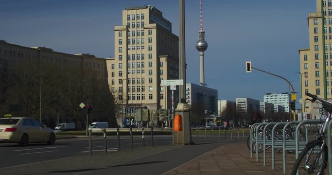 Cyclist making his way through Strausberger Platz, Berlin towards the TV Tower in the distance.