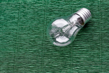 Light bulb on green background. Minimal concept. Copy space