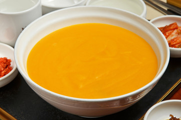 Pumpkin porridge e served with side dish.