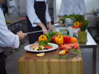 Obraz na płótnie Canvas cook chef decorating garnishing prepared meal
