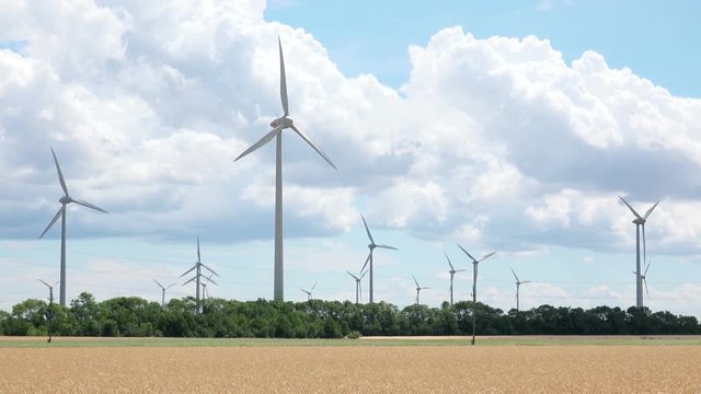 Modern Wind Turbines Farm on Nature Landscape. 4K Ultra HD