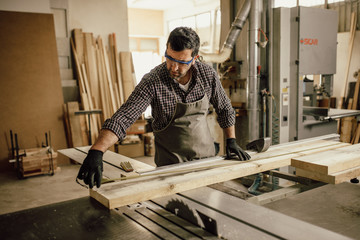 Fototapeta na wymiar Skilled Carpenter craftsman at work in his workshop