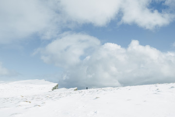 Fototapeta premium Lonely man silhouette on mountain peak. Latrabjarg, Iceland