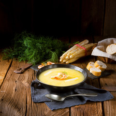 delicious asparagus cream soup with prawns and fresh dill
