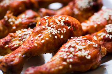Roasted chicken drumsticks covered with sesame