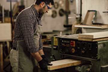 Professional carpenter at work in his laboratory