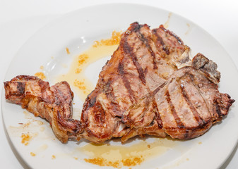 T-bone steak on plate, top view