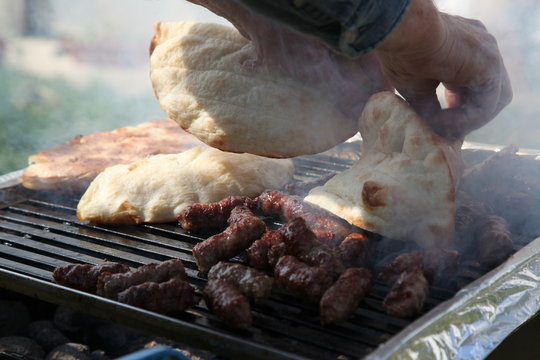 Cevapi (Cevapcici), Bosnian dish prepared on the barbecue and served with Lepinja bread. This dish is popular all over the Balkans, with tourists and locals.