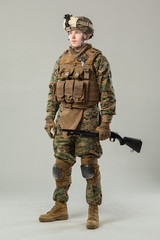 Soldier in camouflage holding rifle