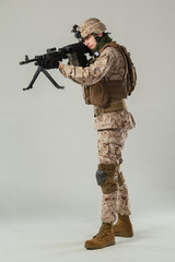 Soldier in camouflage holding rifle