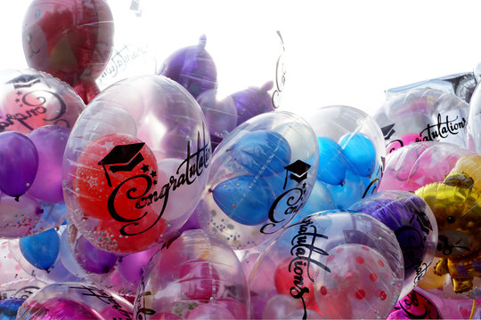 Various size, color ane type of balloons for congratulations graduation on isolated white background.