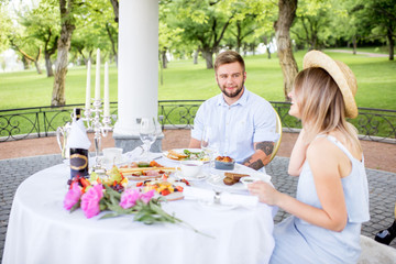 Young couple having romantic breakfast outdoors