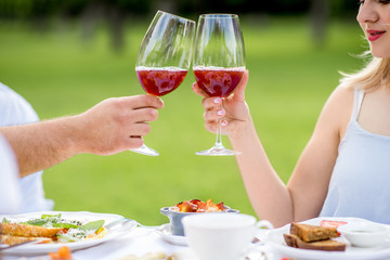 Couple clinking glasses outdoors