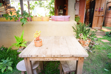 Flowerpot on wooden table, Background for vintage resort hotel
