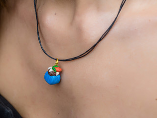 Blue pendant on neck girl