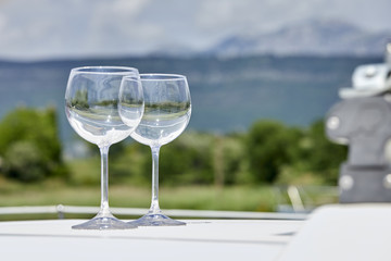 Pair of wineglasses against the yacht