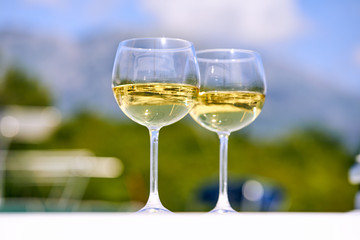 Pair of wineglasses against the yacht