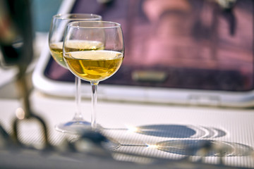 Pair of wineglasses against the yacht