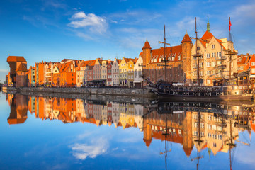 Fototapeta premium Beautiful old town of Gdansk reflected in Motlawa river at sunrise, Poland.