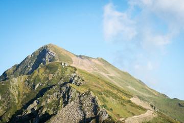Fototapeta na wymiar the top of the mountain on blue sky background