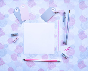 Blank square paper, stationery, badges, clothespins, pens and pencils. Pink and gray mockup