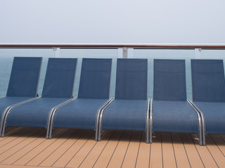 Sun Loungers In a Row On A Cruise Ship Deck