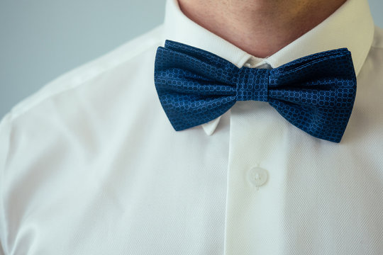 beautiful blue tie butterfly on the white shirt of the groom