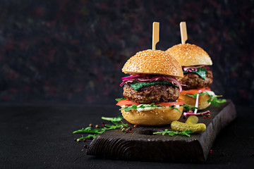 Big sandwich - hamburger burger with beef,  tomato, basil cheese and arugula.