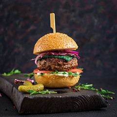 Big sandwich - hamburger burger with beef,  tomato, basil cheese and arugula.