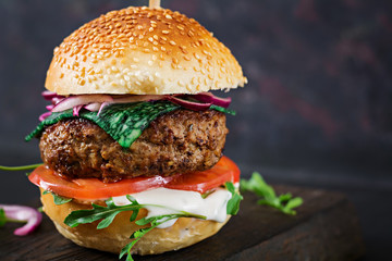 Big sandwich - hamburger burger with beef,  tomato, basil cheese and arugula.