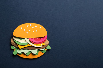 Creative art conceptual collage with space for text. Stylized craft paper burger a red background. Composition cut out from colored paper. Illustrative picture.