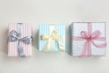Beautifully decorated gift boxes on white background, top view