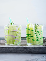 Infused water with cucumber and rosemary herb in glasses. Healthy lifestyle
