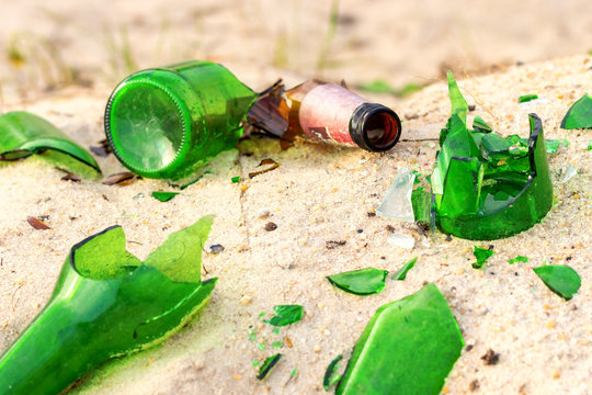 Broken beer glass bottles on a sand