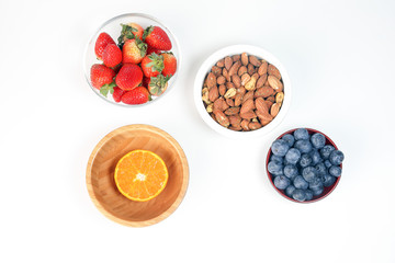 Blueberry Strawberry Herb Spice Almond Cashew Nut Mandarin Orange in bowl on white background