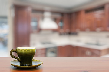 green cup on wooden table