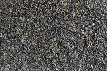 Organic dried green tea leaves . Background, texture.
