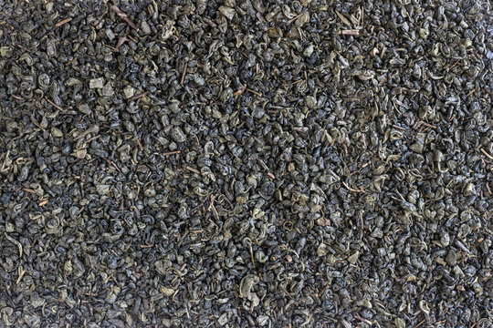 Organic dried green tea leaves . Background, texture.