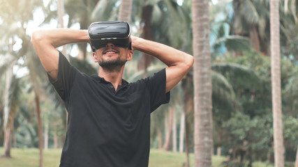 Man using virtual reality headset in the jungle