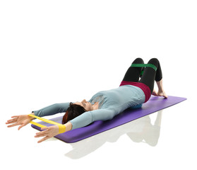 Woman exercising doing postnatal workout. Female fitness instructor working out with a rubber...