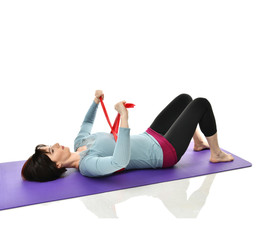 Woman exercising doing postnatal workout. Female fitness instructor working out with a rubber...