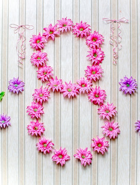 Digit 8 of artificial flowers on the wall