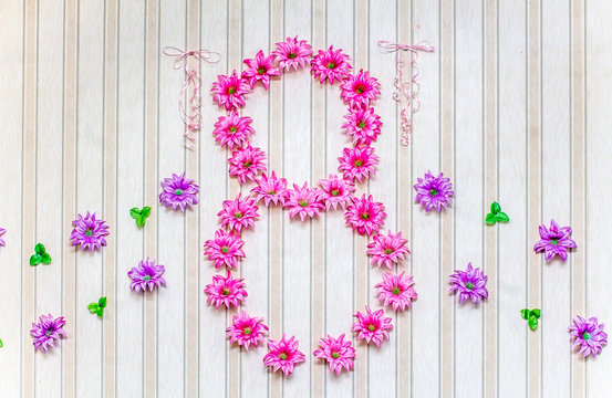 Digit 8 of artificial flowers on the wall