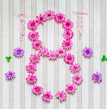 Digit 8 of artificial flowers on the wall