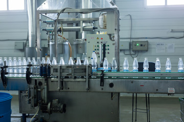 Closeup on mineral water bottles in raw and lines